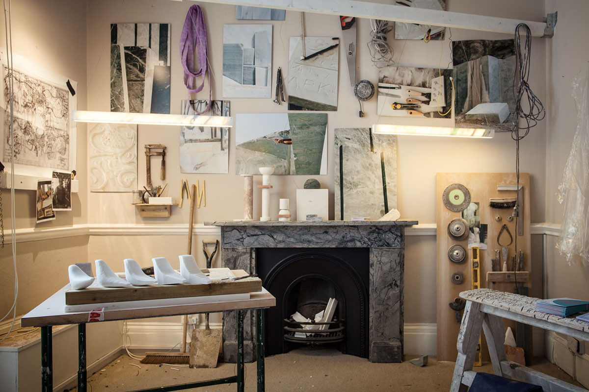 Interior view of OnEntropy’s design studio with marble samples, sculpting tools, sketches, and material studies—showcasing the creative process and craftsmanship behind marble design